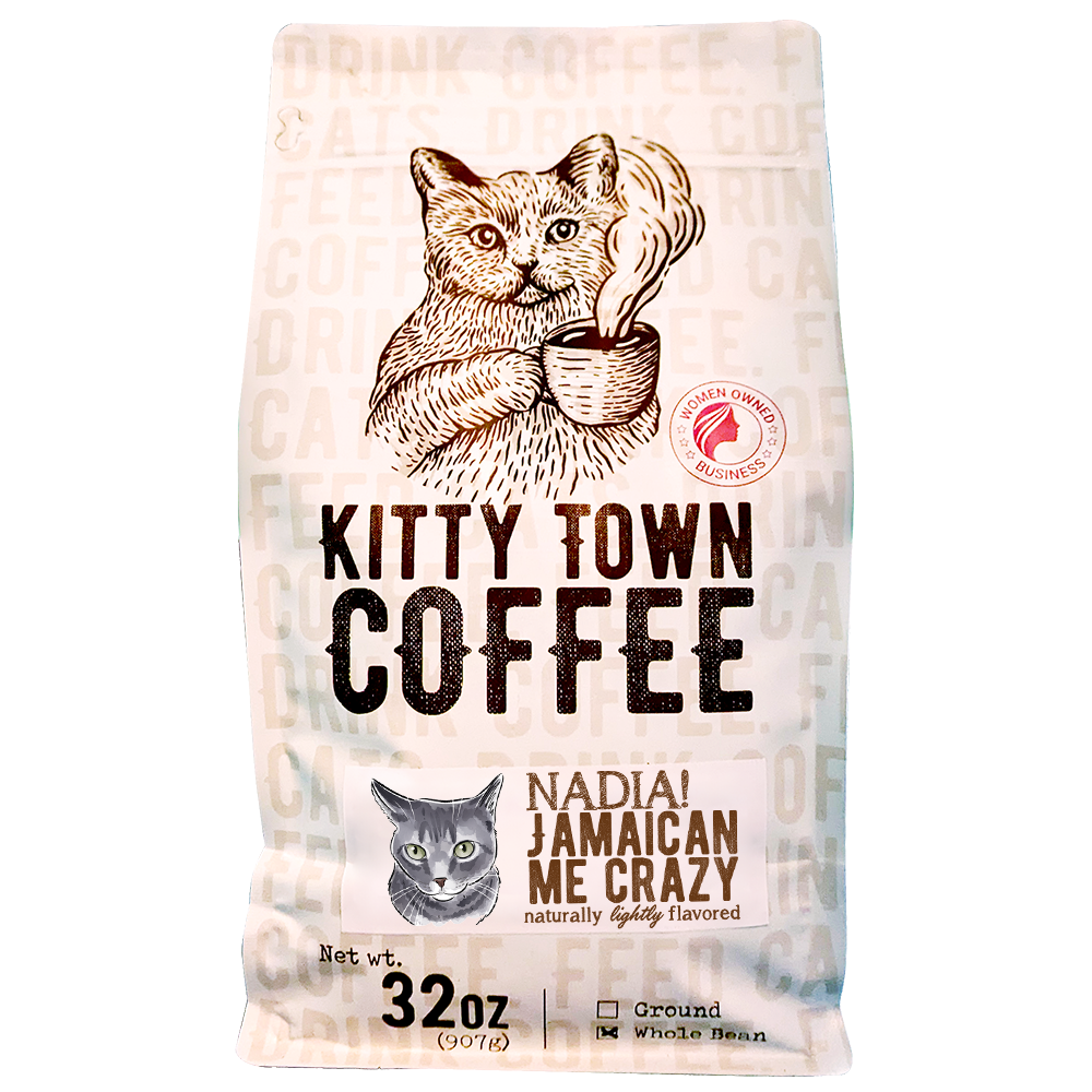 A bag of Nadia! Jamaican Me Crazy! coffee blend featuring hazelnut and caramel flavors, with a playful design representing the Kitty Town family.